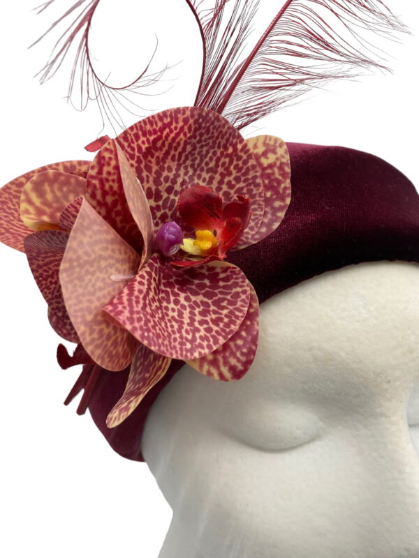 Burgundy Halo crown with orchid flower & feather detail.